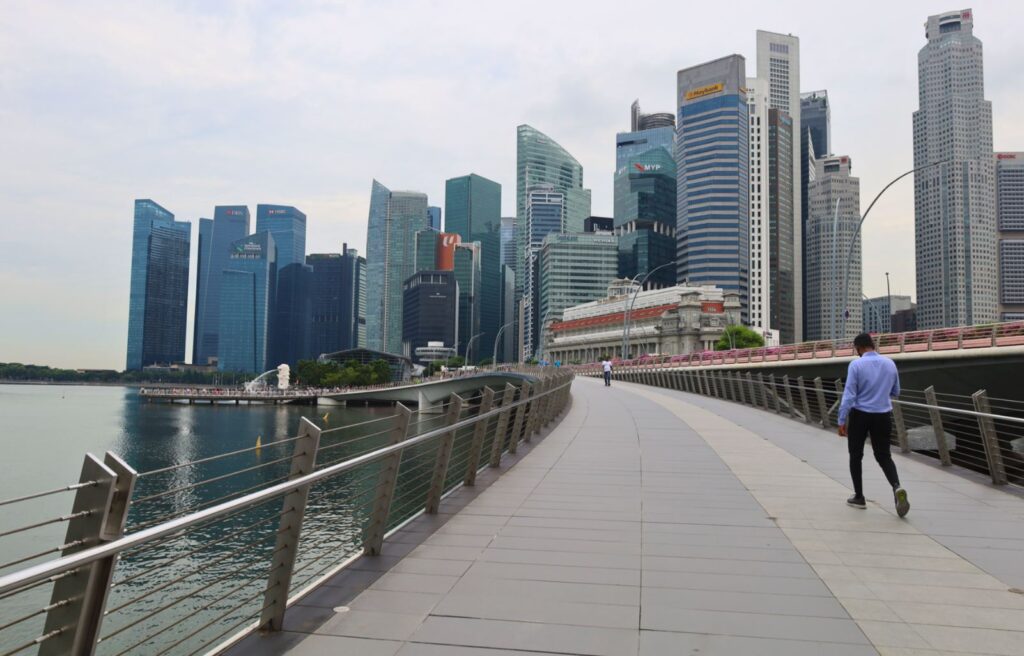 Skyline of downtown Singapore with Marina Bay boardwalk and modern skyscrapers in view