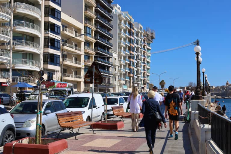 Row of tall apartment buildings along a busy street in Sliema, Malta