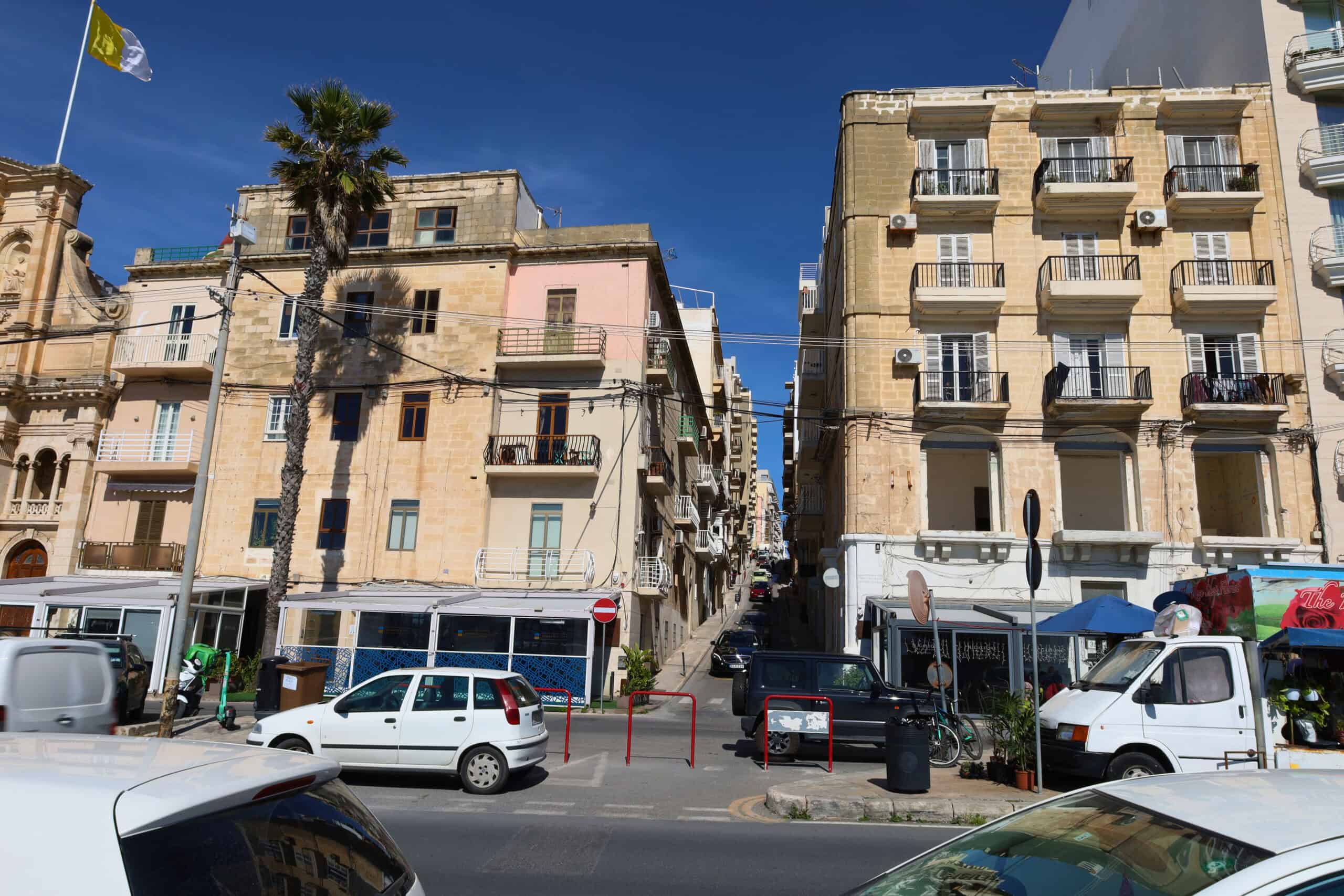 Traditional Maltese balconies with palm trees in Sliema