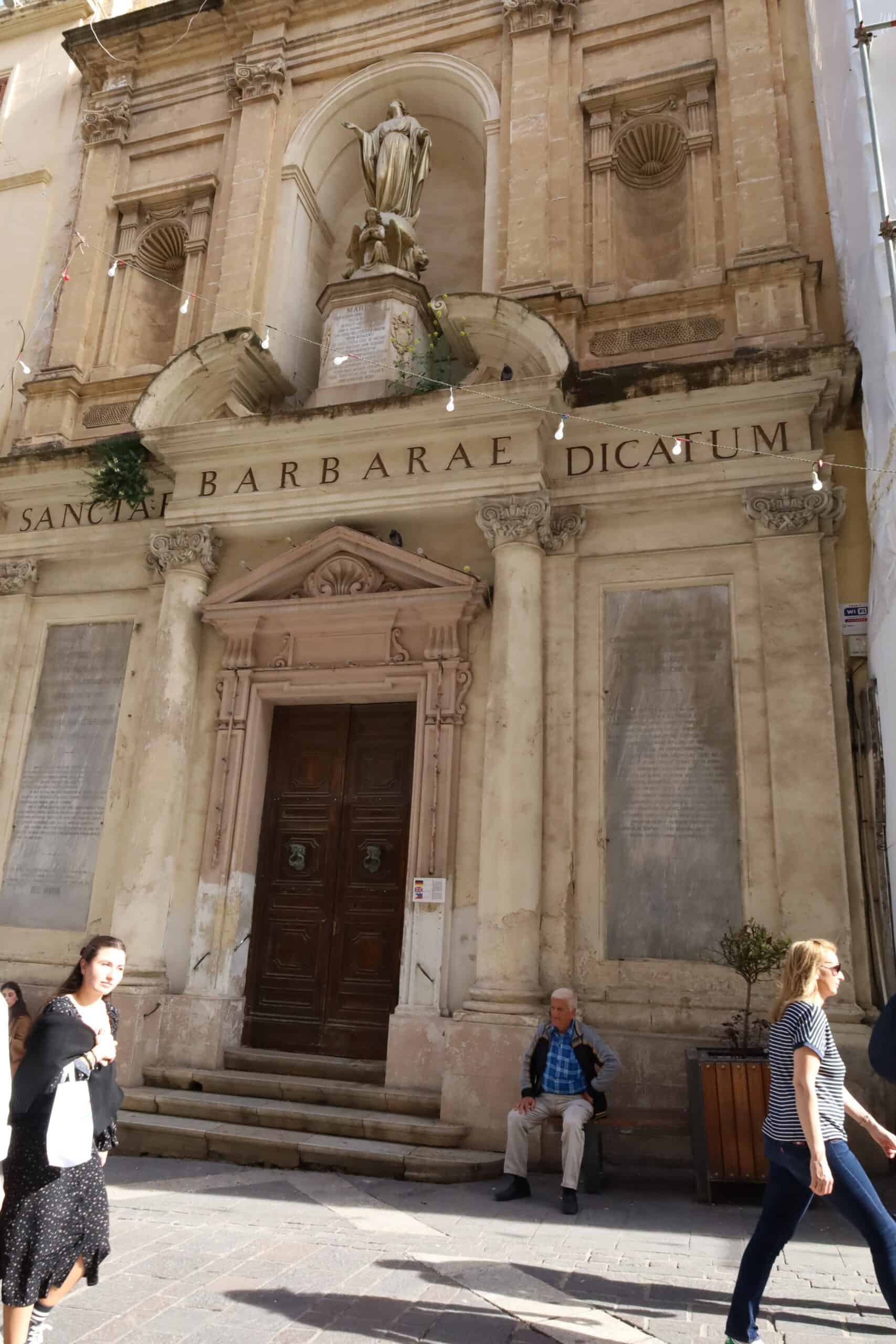 Baroque-style Valletta building with mounted religious statue