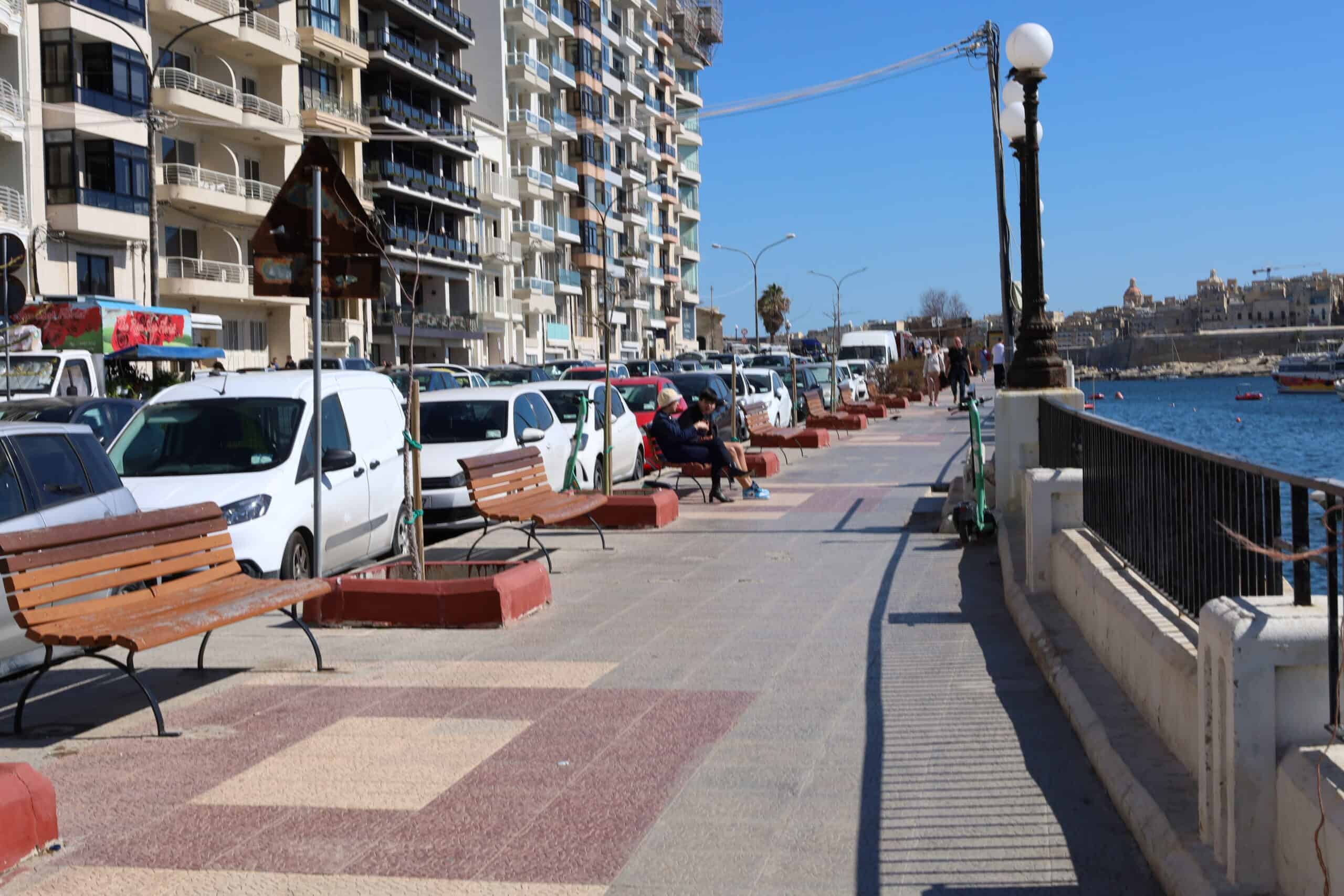 Benches lined up near Maltese coastal apartments