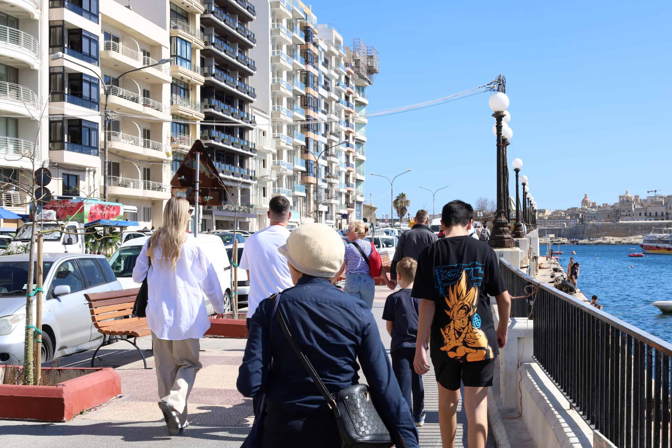 People walking along the busy Sliema promenade in Malta