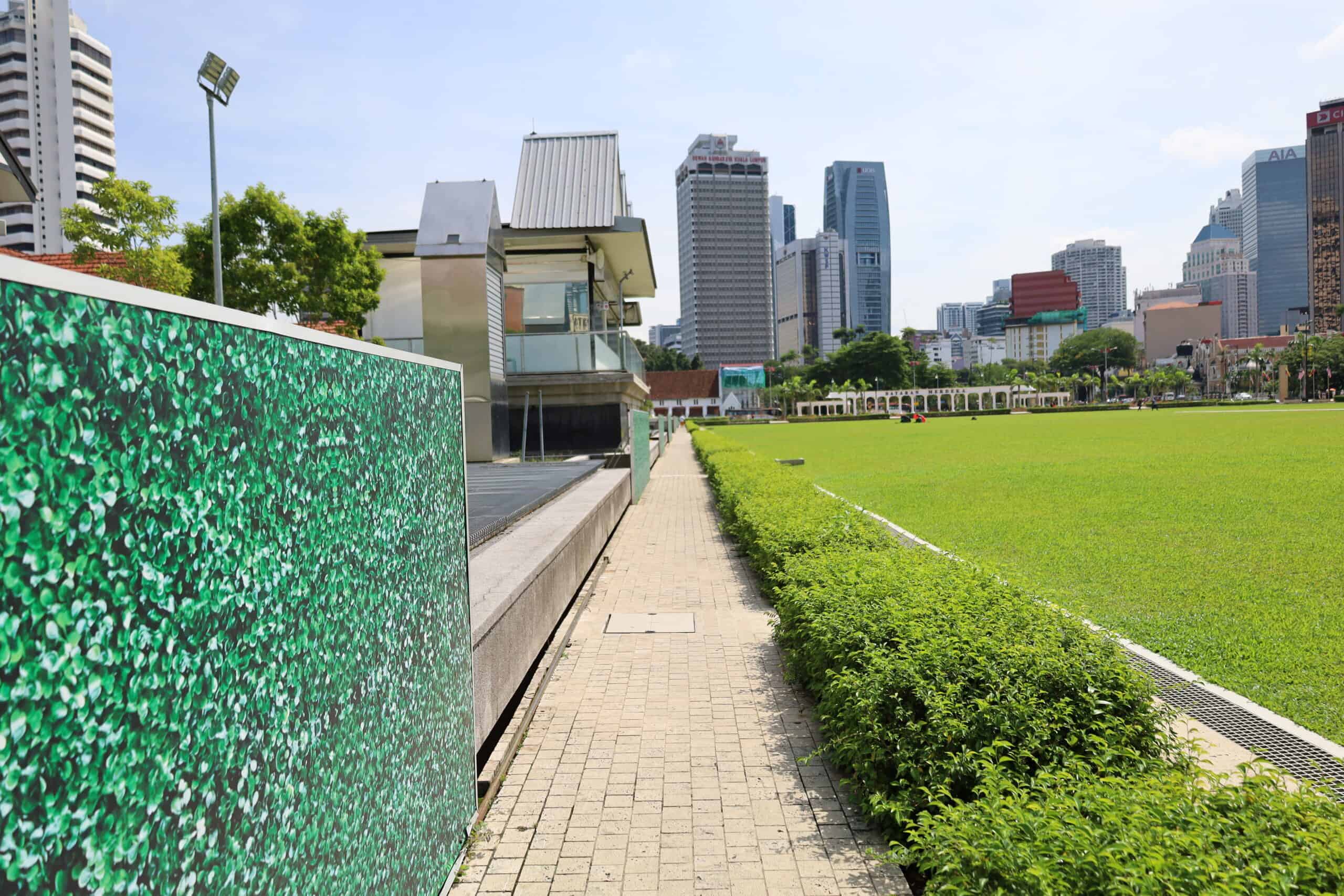 Symmetrical walkway in a green courtyard at Masjid Negara in Kuala Lumpur