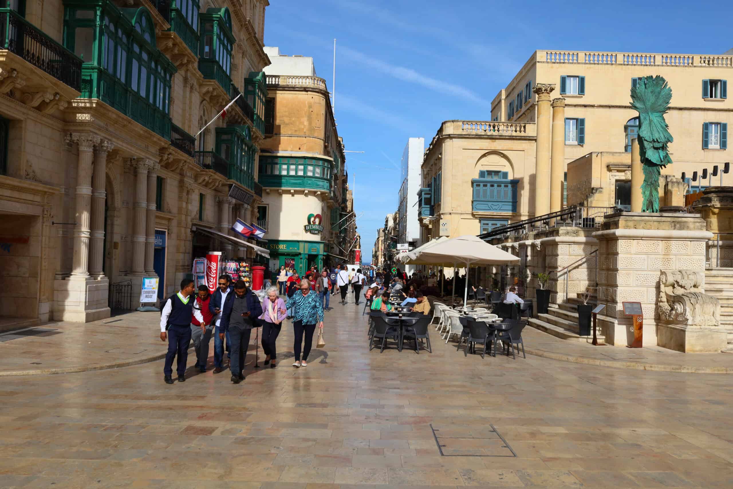 Tourists entering Valletta through a busy city gate