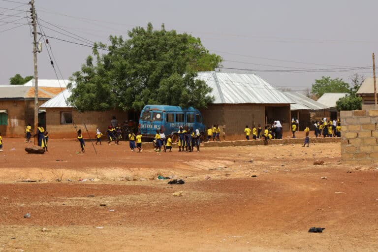Village roadside with children and small businesses in Tamale, Ghana