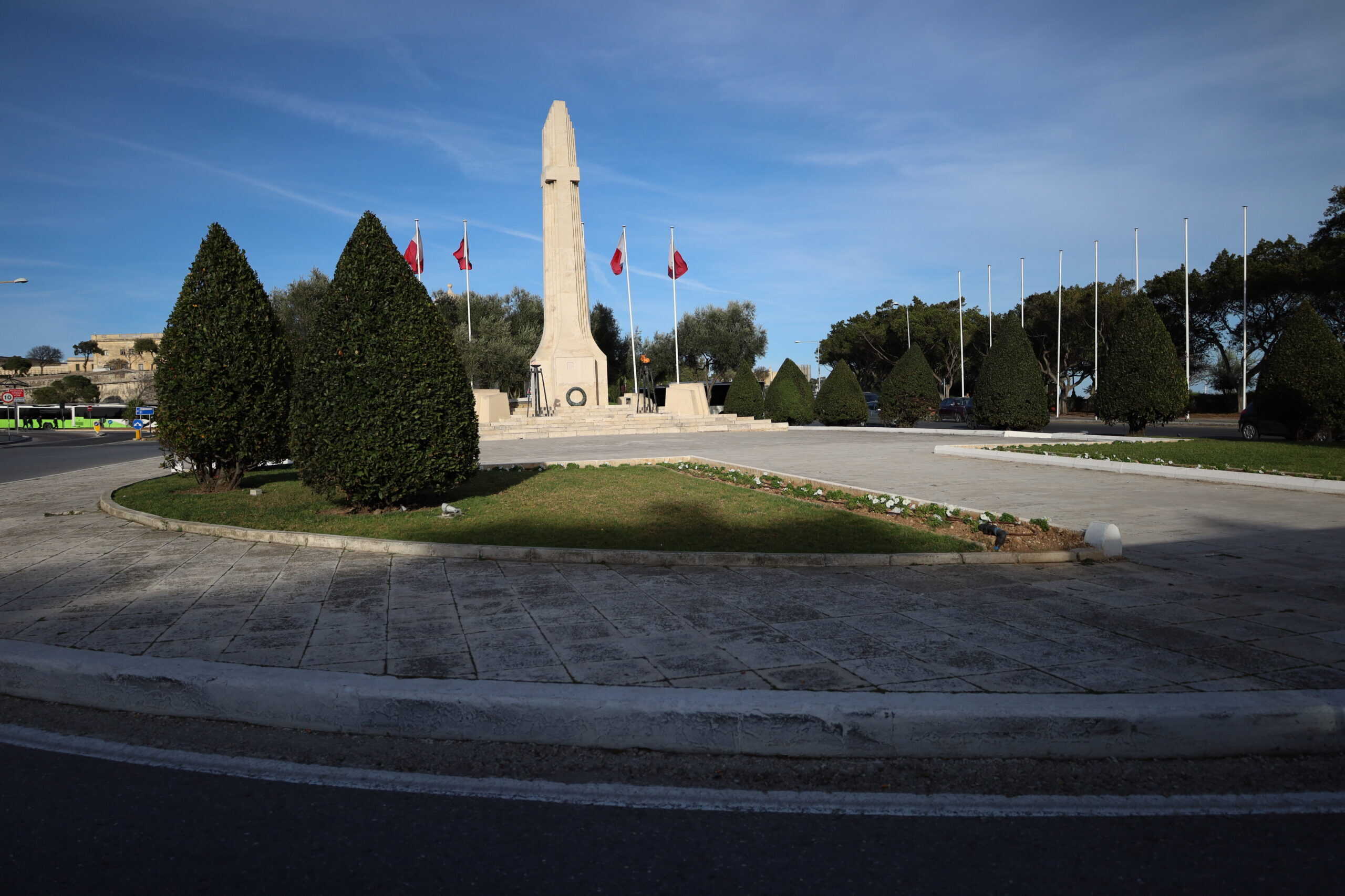 Round garden space near a public monument and obelisk in Malta
