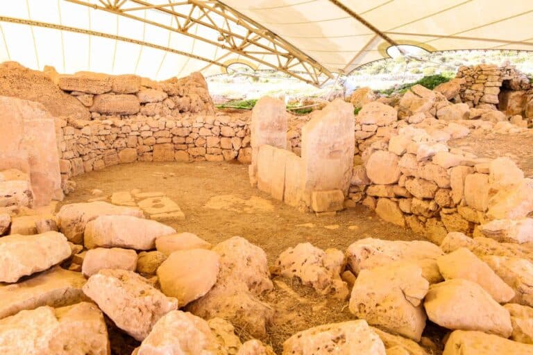Inside view of the Mnajdra temple ruins with circular stone arrangements.