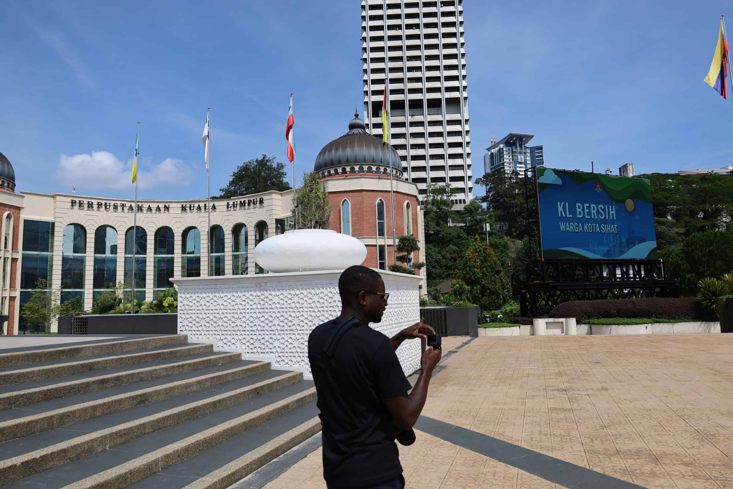 Man walking past the Sultan Abdul Samad Building in Kuala Lumpur