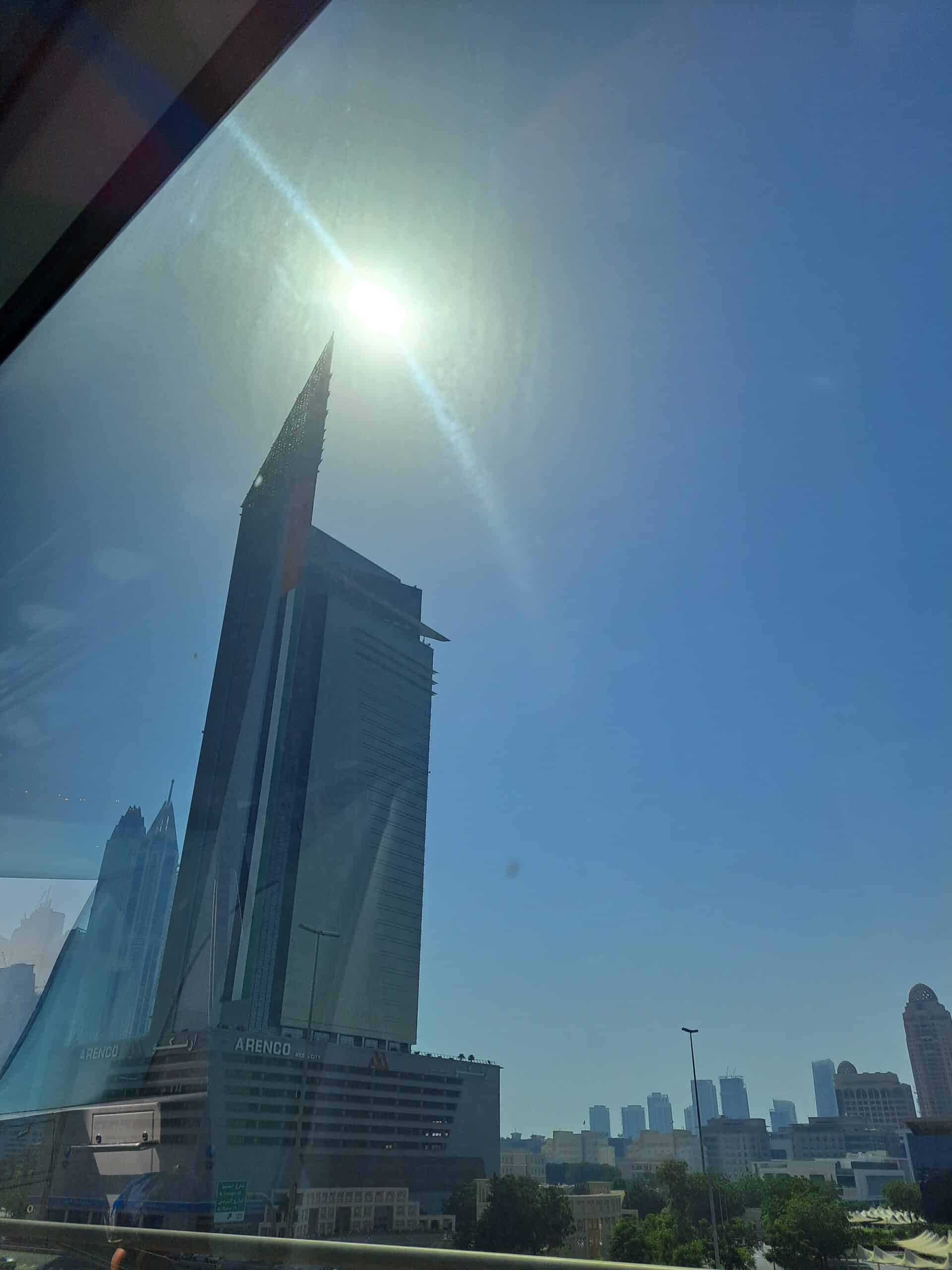The Burj Khalifa seen through a tinted window with the sun shining overhead