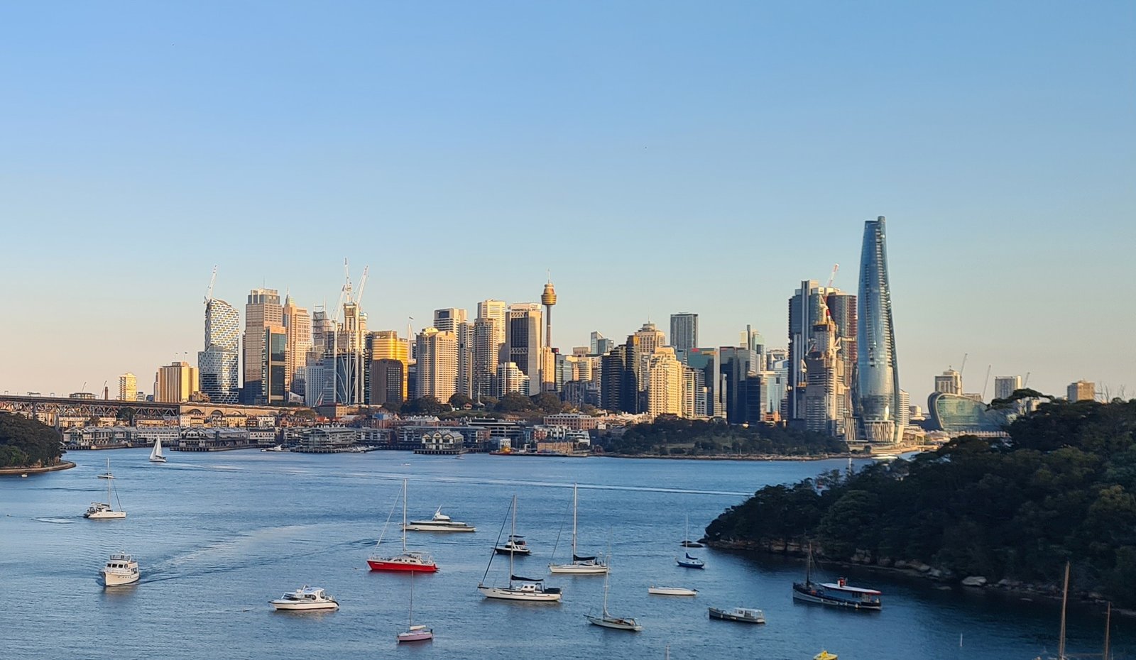 View of Sydney skyline and harbor at sunset in Australia.