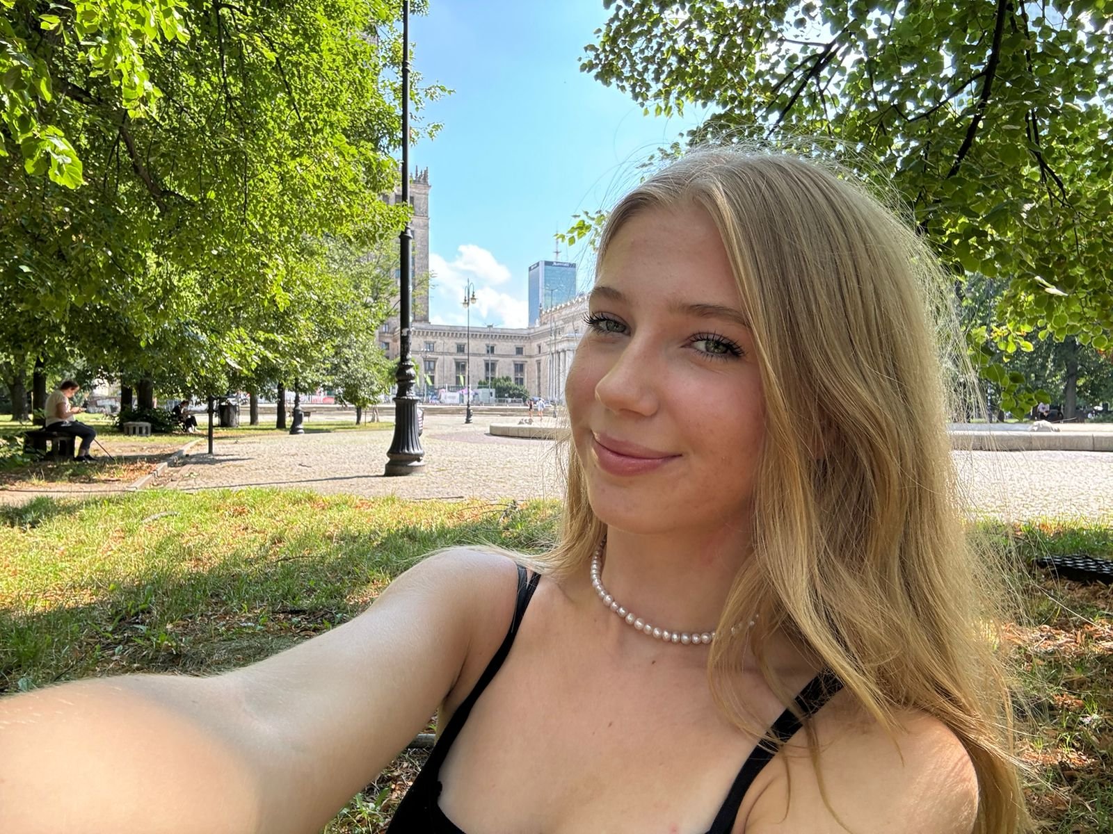 Julia Zmuda, American-Polish presenter and cultural contributor for Explore With Kojo, photographed outdoors in Warsaw, Poland.