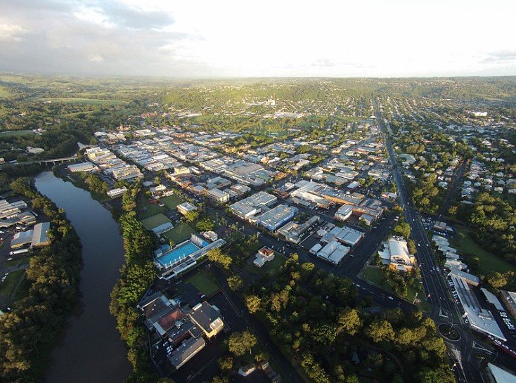 Aerial view of Lismore, New South Wales surrounded by trees and a river