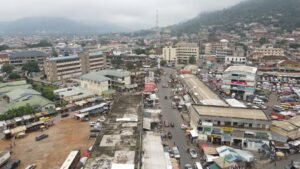 Central Koforidua on a busy morning with traffic and vendors