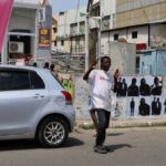 Crossing guard assisting pedestrians in Accra’s commercial district
