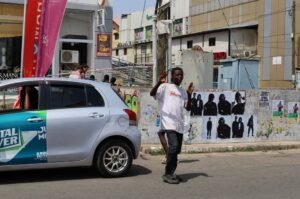 Crossing guard assisting pedestrians in Accra’s commercial district