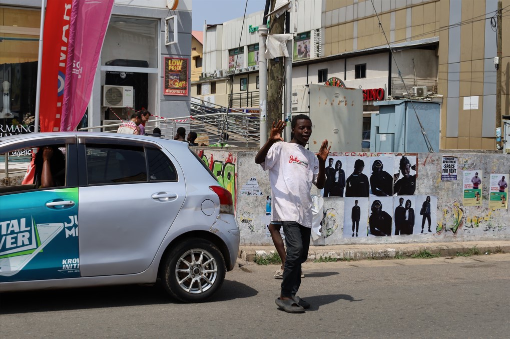 Crossing guard assisting pedestrians in Accra’s commercial district