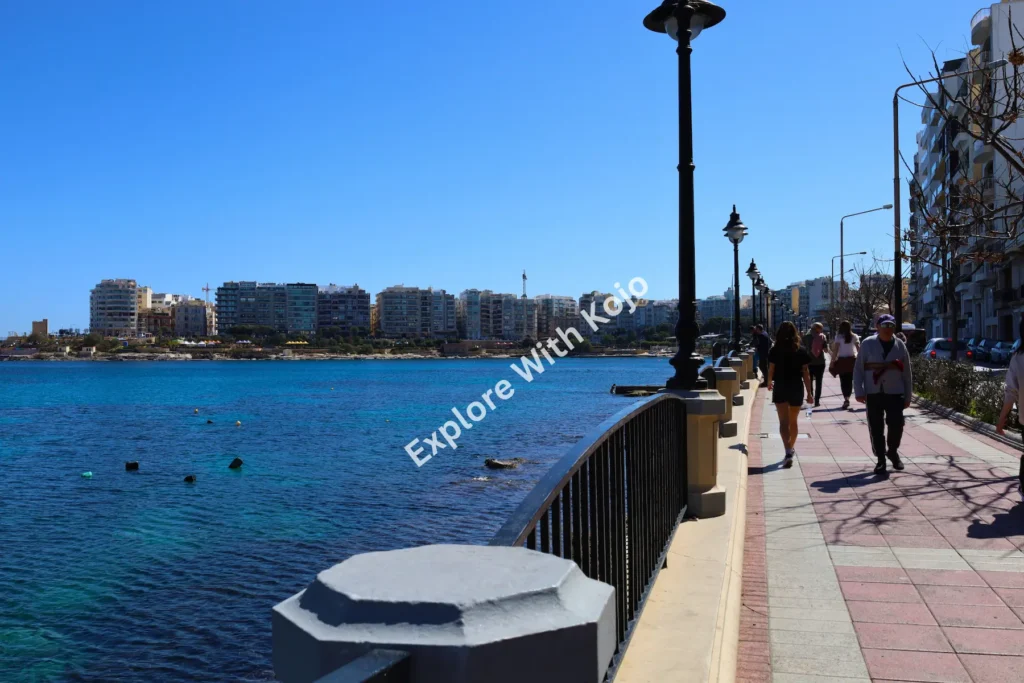 People walking along the harbor promenade with sea views in Malta. 10. car-parked-on-corner-street-malta