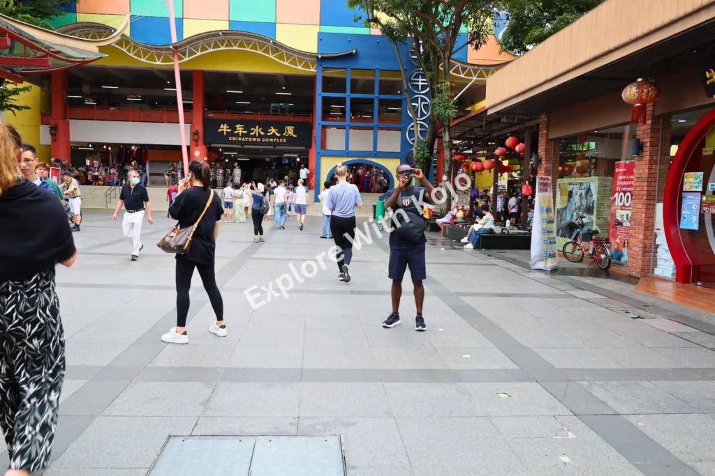 Street life in Chinatown Singapore with tourists.