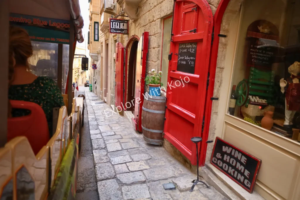 Colorful doorway with red paint in a narrow Valletta street, Malta.