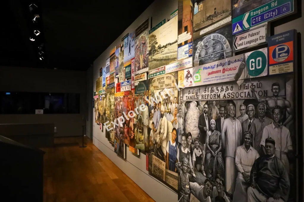 Heritage wall with photographs, signs, and community art at the Indian Heritage Centre Singapore.