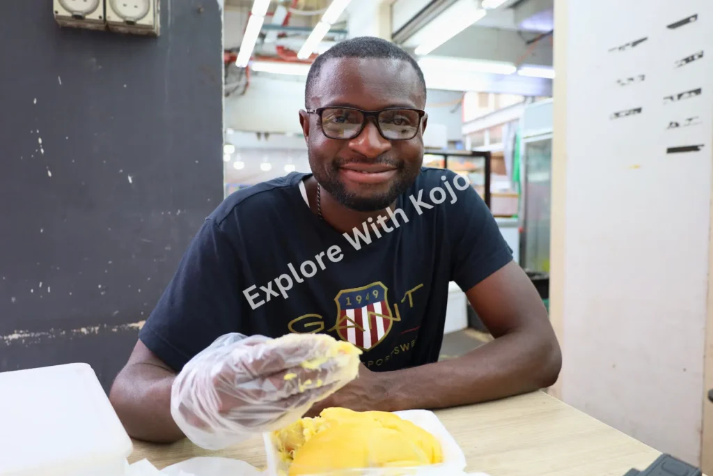 Kojo eating durian in Chinatown Singapore