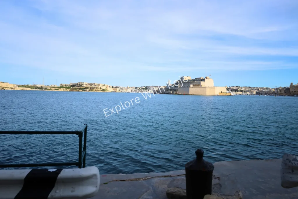 Scenic Malta harbor with a bench by the waterfront.