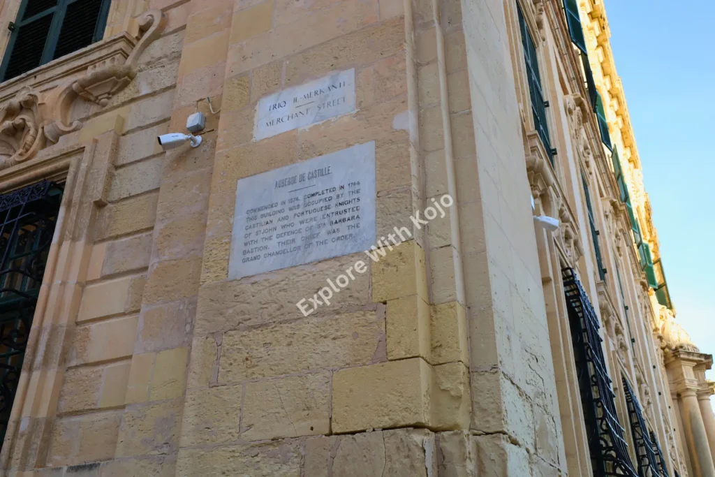 Historic plaque on limestone building wall in Valletta, Malta.