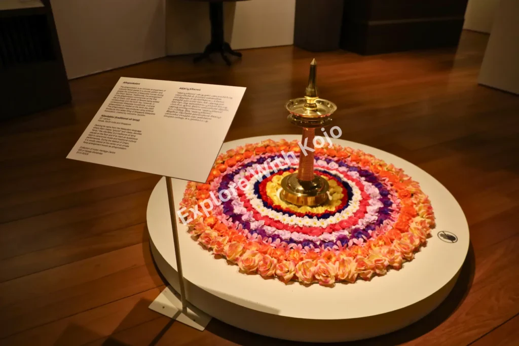 Colorful rangoli design with a brass lamp at the Indian Heritage Centre in Singapore