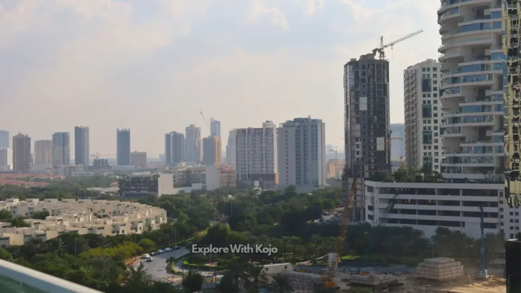 Skyline view of Jumeirah Village Circle in Dubai with residential towers, villas, and ongoing construction.