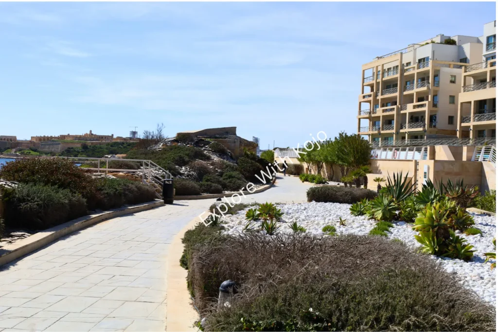 Landscaped seaside walkway with plants along the Malta coast.