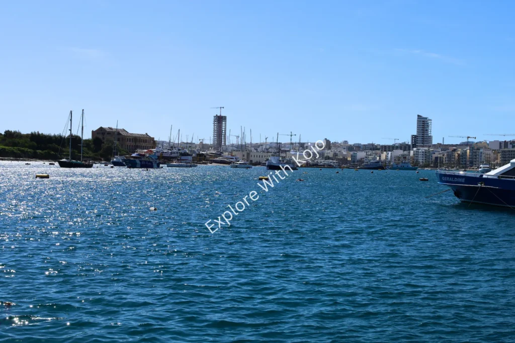 Scenic harbor view with yachts and blue waters in Malta.