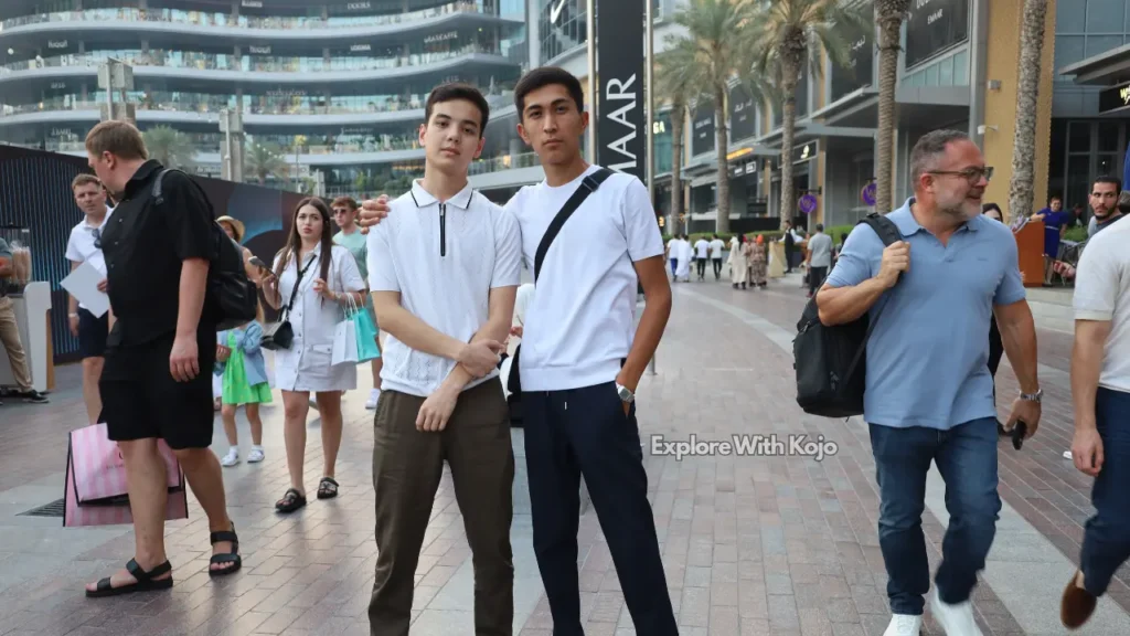Expats walking near the Burj Khalifa and Dubai Mall, showcasing the diverse international community in Downtown Dubai.