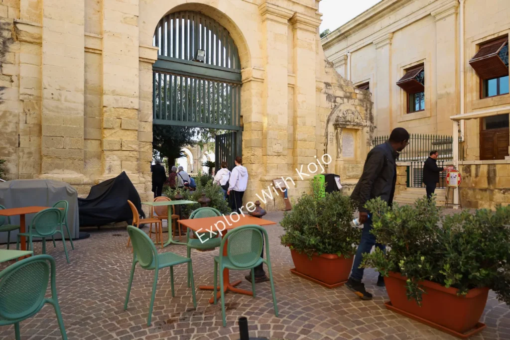 Tables and chairs in a courtyard outdoor seating area in Valletta, Malta.