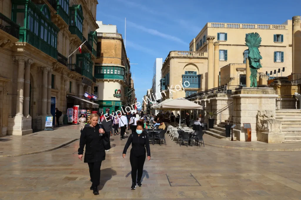 People walking along Republic Street in Valletta, Malta.
