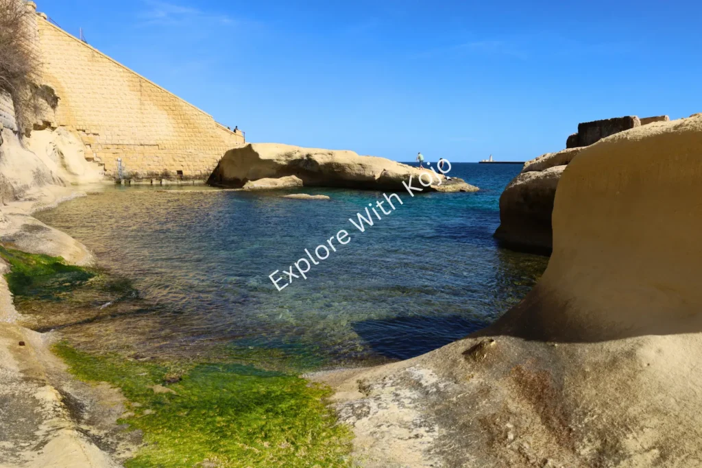 Secluded cove with golden cliffs and sea in Malta.