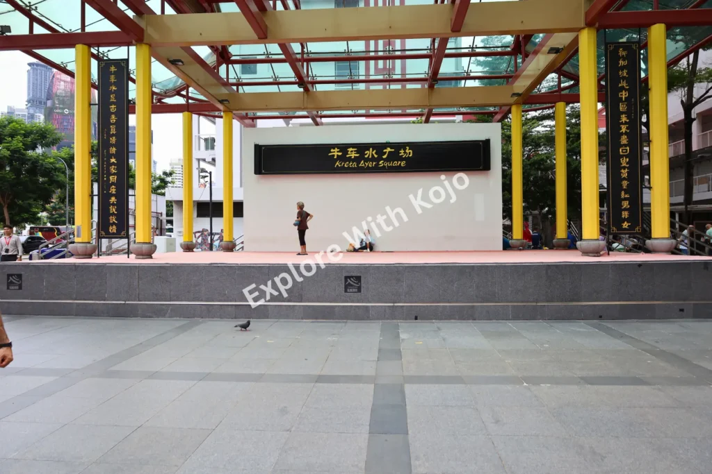 Chinatown Singapore community stage with colorful columns.