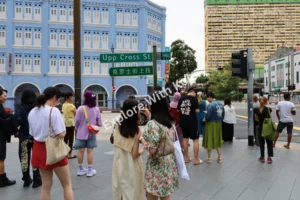 Crowds of people on a busy street in Singapore Chinatown.