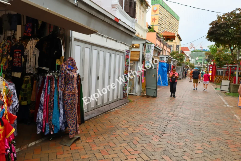 Street market in Singapore&rsquo;s Chinatown with shoppers and shops.
