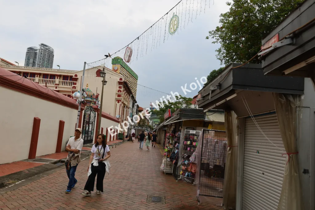 Small side street in Chinatown Singapore with shops and heritage buildings.