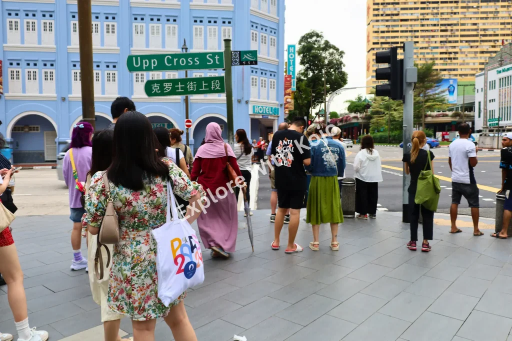 Tourists crossing a road in Singapore Chinatown.
