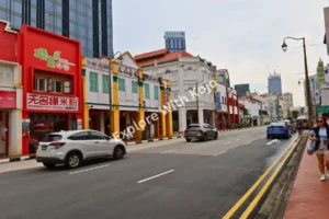 Colorful shophouses along a busy street in Singapore.