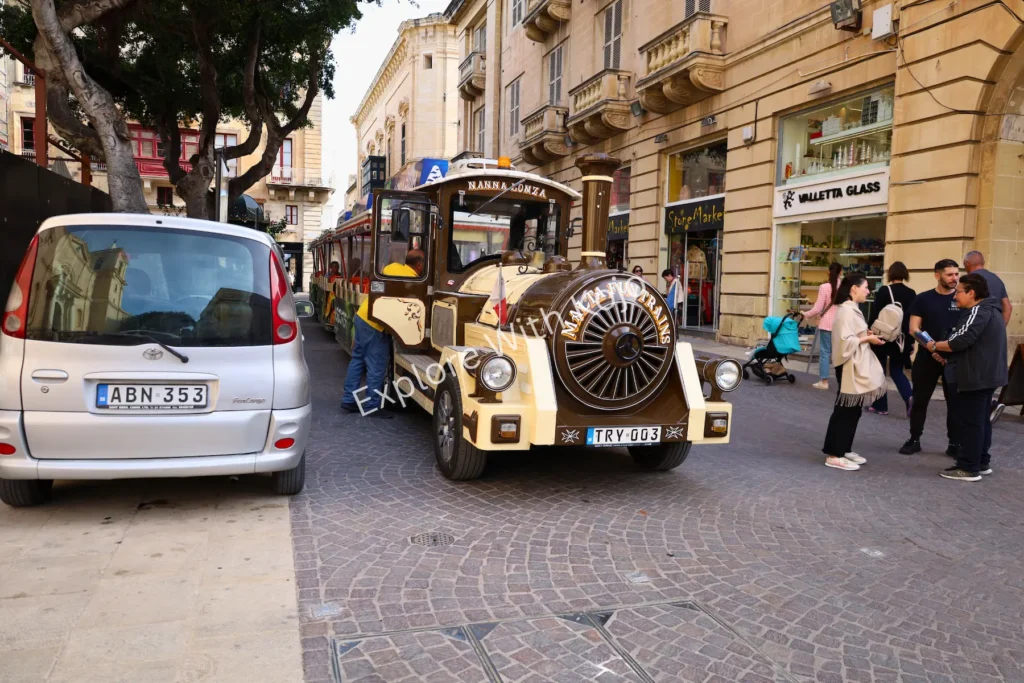 Sightseeing tourist train in Valletta street Malta.