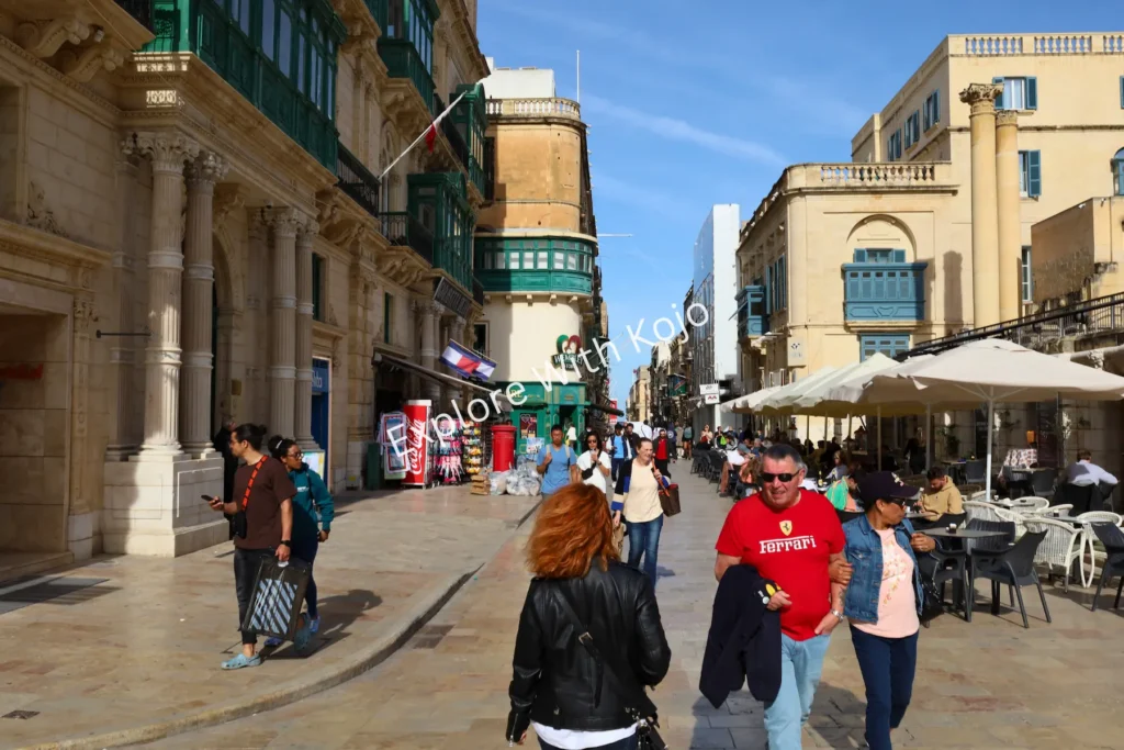 Tourists and locals on Republic Street in Valletta, Malta.
