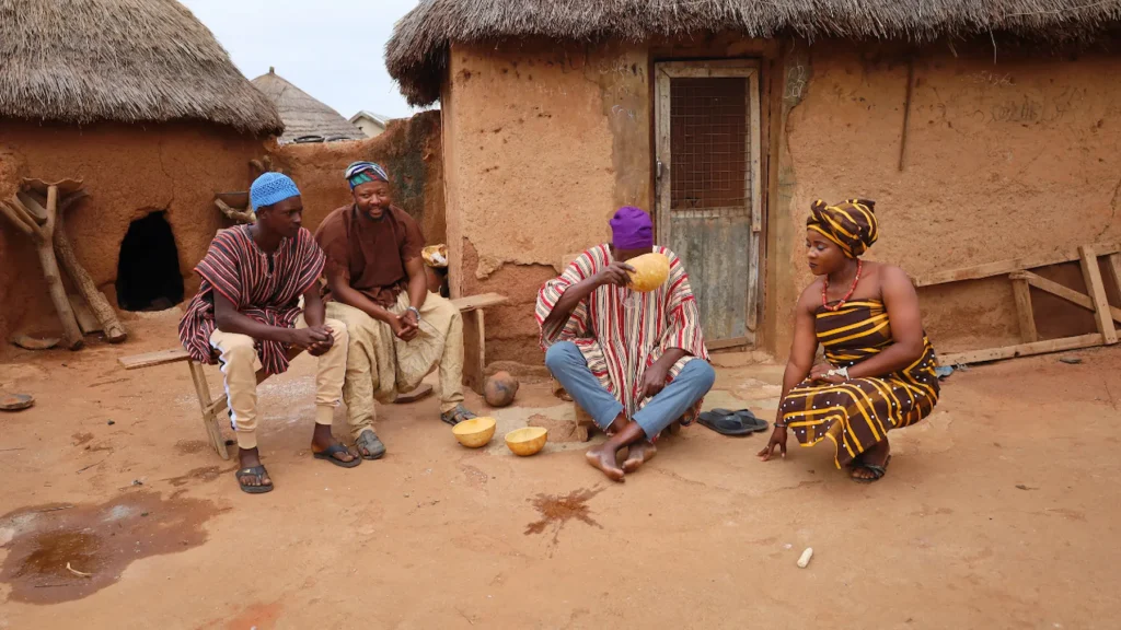 African groom meeting with the bride’s family in a traditional village marriage setting.