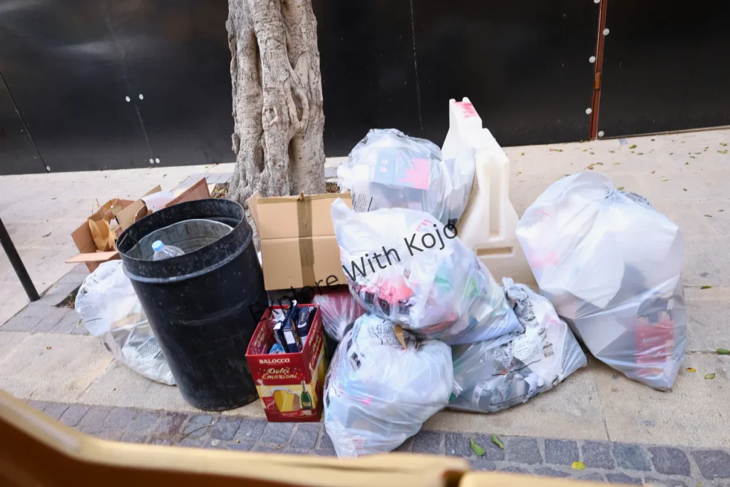 Trash bags piled on a street corner in Malta.