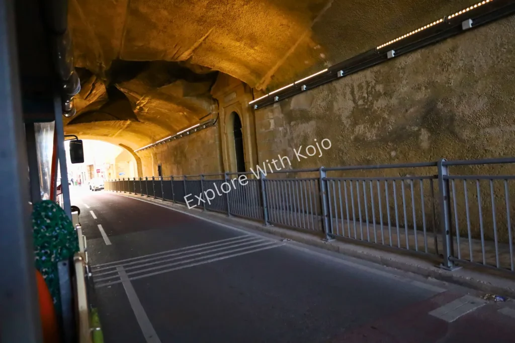 Walkway underpass in Valletta Malta with stone walls.