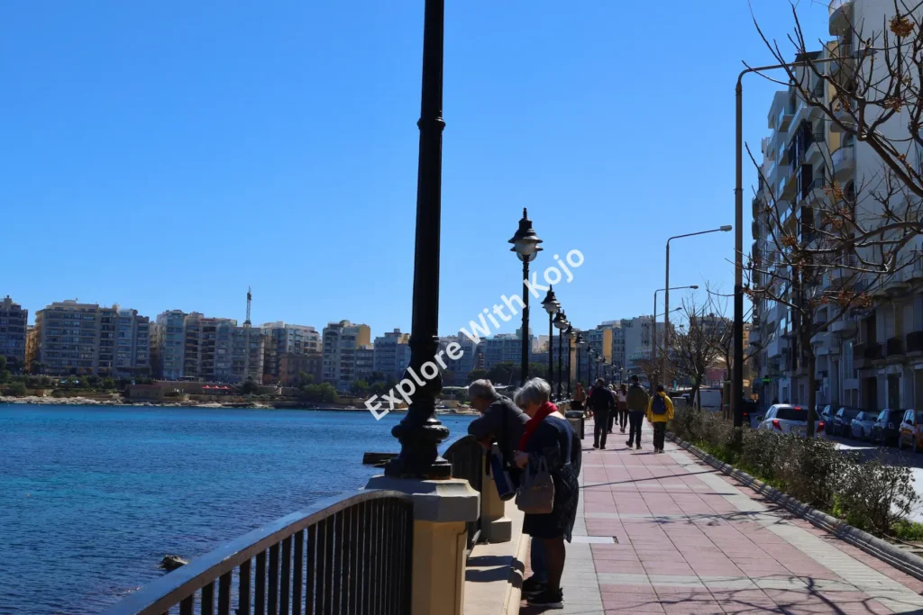People walking on waterfront promenade in Malta.