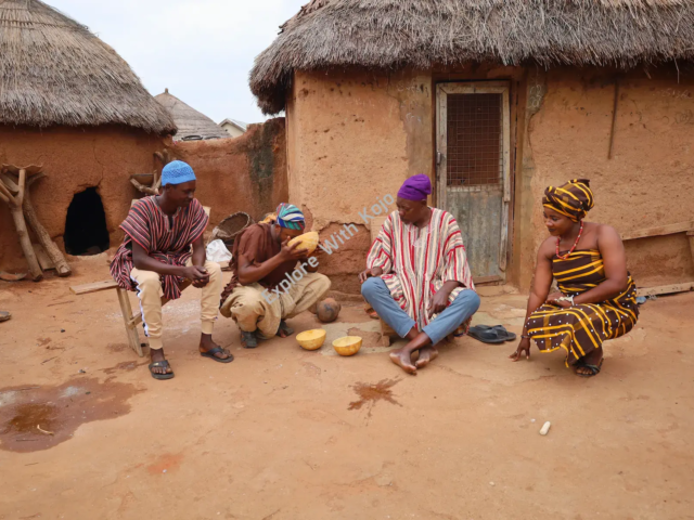 African family outside a mud hut in traditional village