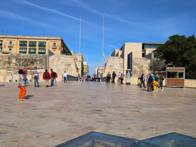 People walking near the City Gate in Valletta, Malta