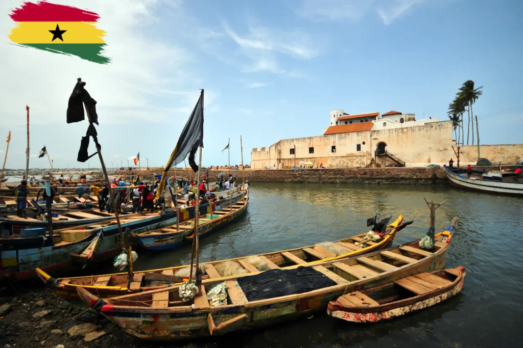 Traditional fishing boats docked along the coast in Ghana.